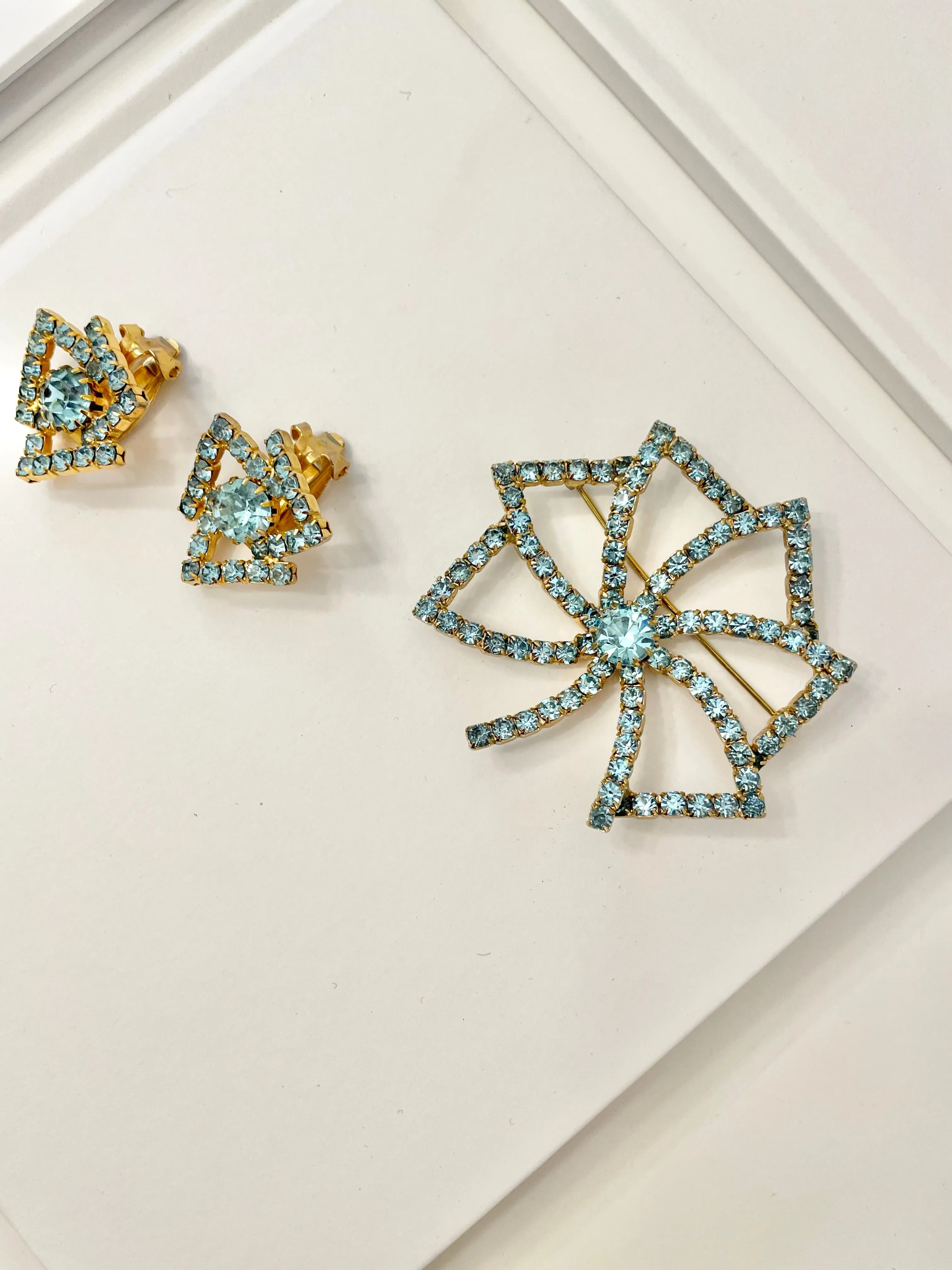 1960's Heiress and her love of a classy brooch set. This aqua glass brooch and earrings are truly divine.